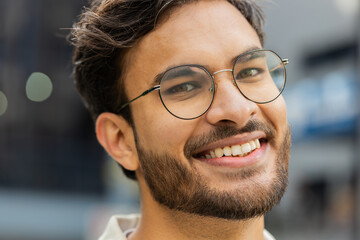 Portrait of happy young Indian man face smiling friendly, glad expression looking at camera...