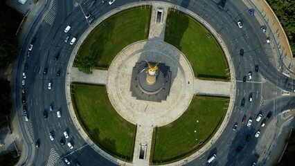 Aerial top view shot of the golden Victory Column monument's square in Berlin, Germany
