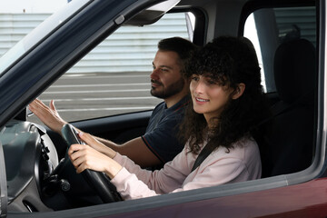 Driving school. Student during lesson with driving instructor in car