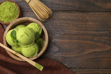 Tasty matcha ice cream, bamboo spoon with powder and whisk on wooden table, flat lay. Space for text
