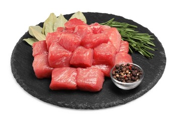 Pieces of raw beef, bay leaves, rosemary and peppercorns isolated on white