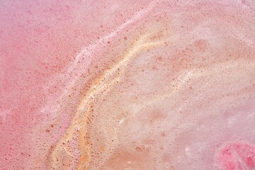 Colorful foam after dissolving bath bomb in water, closeup