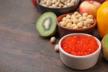Many different products on wooden table, closeup and space for text. Natural sources of serotonin
