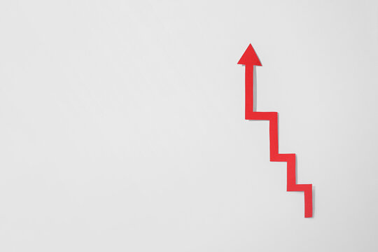 Red zigzag paper arrow on white background, top view. Space for text