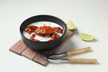 Delicious boiled crab with cream sauce and lime served on white table
