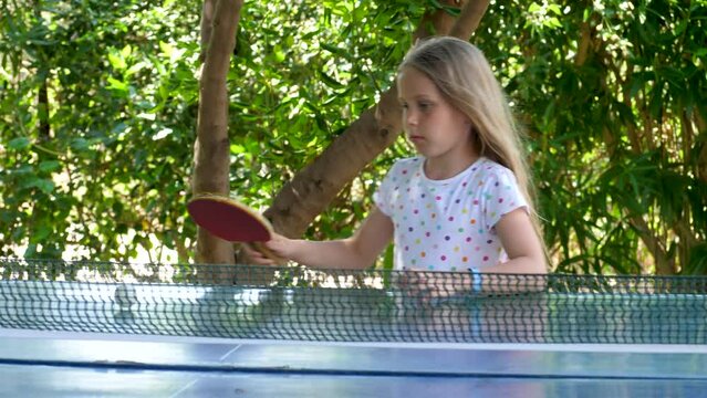 Player girl can't hit lightweight ping-pong ball back in table tennis game. Tennis net use small rackets. Sport game is fast and demands quick reactions. Table tennis has been an Olympic sport