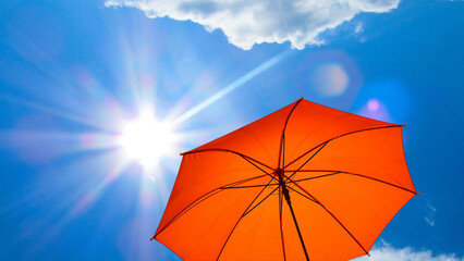 umbrella in the sun against blue sky. Hot summer relaxation and vacation concept © Png Stock Market