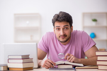 Young male student sitting in the classroom