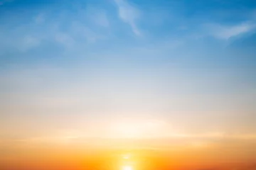 Tuinposter Real amazing Beautiful sunrise and luxury soft gradient orange gold clouds with sunlight on the blue sky perfect for the background, take in everning, Twilight sunset sky with gentle colorful clouds © ISENGARD