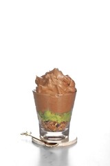 iced avocado coffee, fresh blended avocado poured one shot of espresso in a plastic cup on a wooden coaster