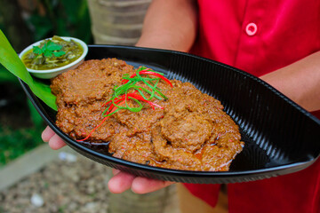 Beef Rendang is a Minang dish originating from the Minangkabau region in West Sumatra, Indonesia. Rendang has been slow cooked and braised in a coconut milk seasoned with a herb and spice mixture