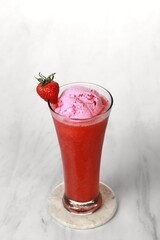 Strawberry juice with ice cream is served in a very luxurious clear glass. isolated in white and dark background
