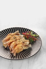 flour fried shrimp with salted egg on a plate
