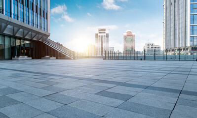 Empty brick road in front of office buildings