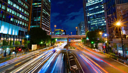Fototapeta na wymiar A night traffic jam at the city crossing in Tokyo wide shot