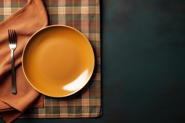 Top down view of a table setting featuring a vacant plate knife fork and napkin allowing for creative use of empty space - obrazy, fototapety, plakaty