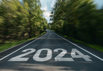Road to new year 2024 has written on the road in the middle of asphalt road, Planning of new year to achieve net zero and carbon emission reduction concept.