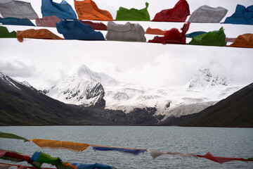 Snow-covered mountain across lake in Tibet, China