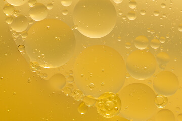 Oil bubble texture on gold background.