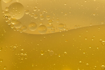 Oil bubble texture on gold background.