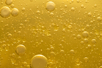 Oil bubble texture on gold background.