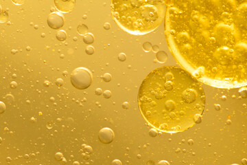 Oil bubble texture on gold background.