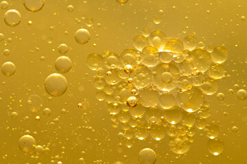 Oil bubble texture on gold background.
