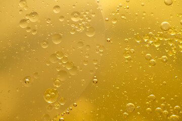 Oil bubble texture on gold background.