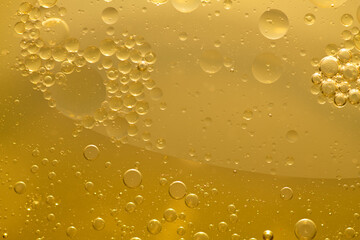 Oil bubble texture on gold background.