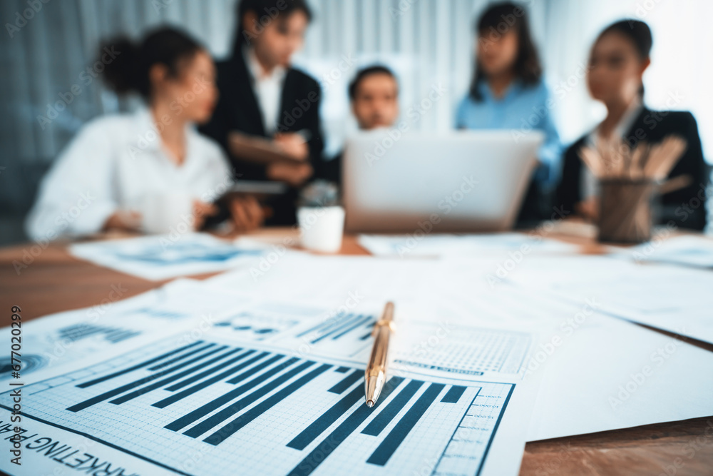 Aufkleber piles of analyzed financial data dashboard on meeting table with background of business people analy