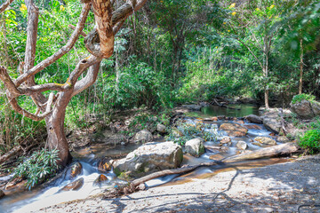 beautiful cascading waterfall over rocks long exposure in Chiangmai Chiang mai mountains northern thailand amongst lush green tropical rainforest