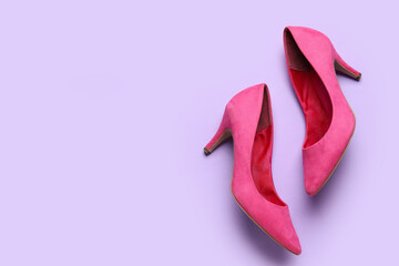 Stylish pink high heels on lilac background