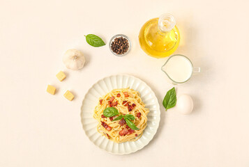 Plate with tasty pasta carbonara and ingredients on white background
