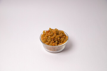Yellow colour golden raisin on glass bowl, Natal dried raisin in white bowl, yellow raisin in white background, Kismis on glass bowl