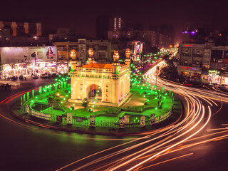 Fototapeta na wymiar karachi cityscape at night, Bahadurabad Roundabout illuminating in green colour on occasion of 12th Rabiulawal celebrations, landmarks of karachi.