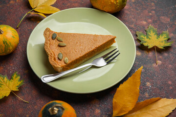 Autumn composition with tasty pumpkin pie on brown background