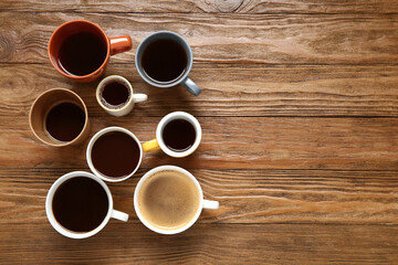 Many cups of hot coffee on wooden background