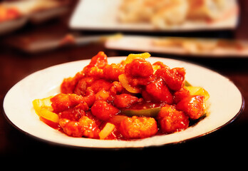 Spicy stir-fried chicken Korean food on white plate, selective focus