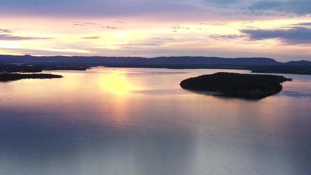 Lake Macquarie at sunset – Dangar island in lights of setting sun aerial 4k.
