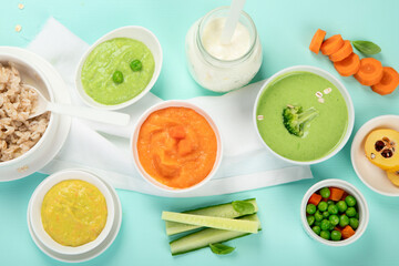 Fototapeta na wymiar Bowls with different healthy baby food.