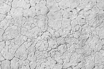 Cracked floor. Dirty broken old concrete wall background. White gray cement wall being cracked backdrop. Rough and grunge texture surface. Black and white background.