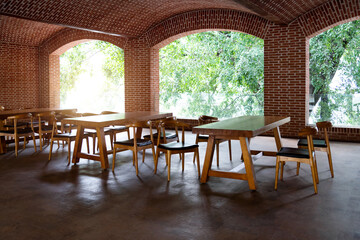 Red brick restaurant with tables and chairs
