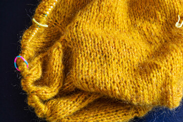 unfinished knitted work, cozy atmosphere, women's hobby knitting, the beginning of the sock...