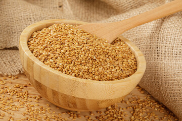Wooden bowl filled with healthy and delicious Roasted Flax Seeds