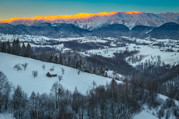 Fantastic winter landscape with snowy mountains at sunrise, Carpathians, Romania