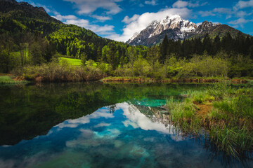 Beautiful clean mountain lake and snowy peaks in Slovenia