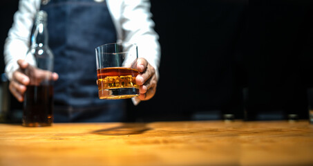 Barman pouring whiskey whiskey glass..