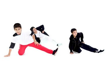 Happy student kid group studying modern style dance in indoor studio classroom, children, boys and girl, dancing on white background. Three little dancers practicing break dance together.