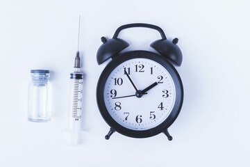 Time for vaccination. Watch and syringe with vaccine. Date and time of preventive vaccinations to...