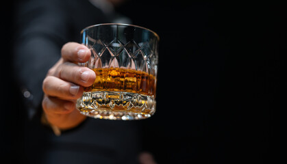 Bartender pours whiskey to customer in tavern